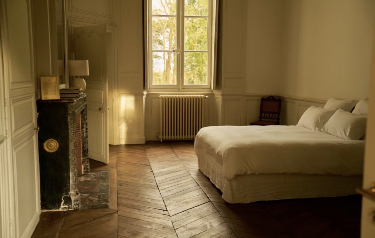 A sunlit château bedroom