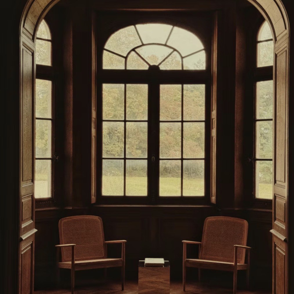 Two chairs by a château window